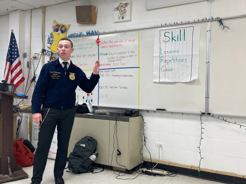 Young Man in FFA Jacket at White board