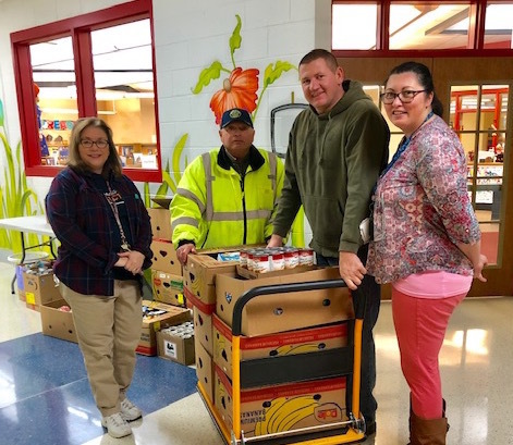Clarkson FRC staff with food drive items on a cart