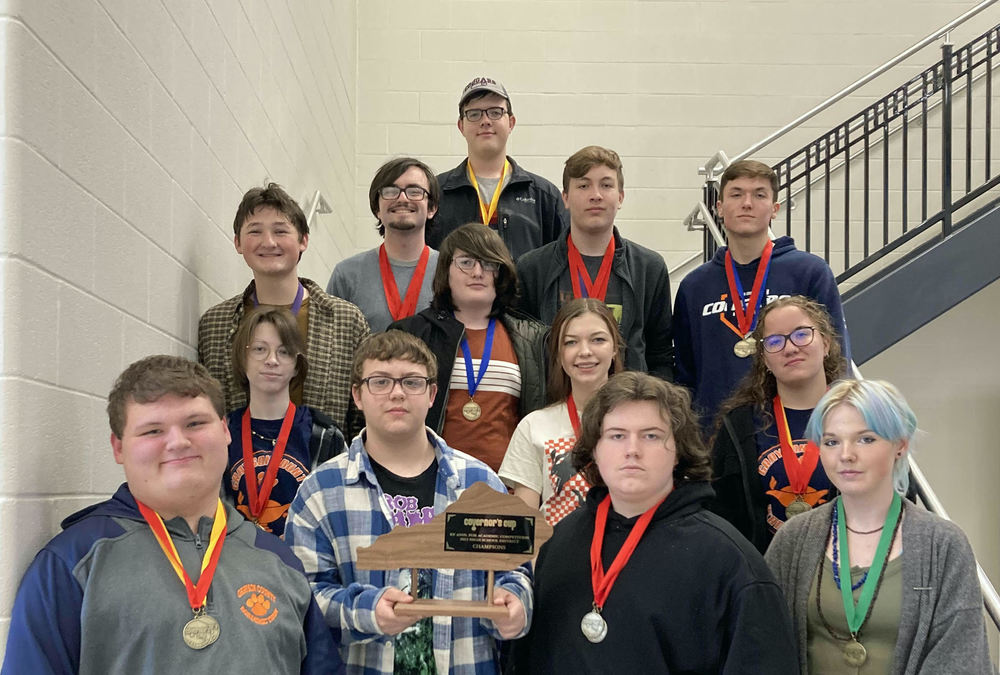 GCHS Academic Team - District Winners standing on stairs in 4 rows with award medals around their necks. (see article for names, not id'd by placement in photo))