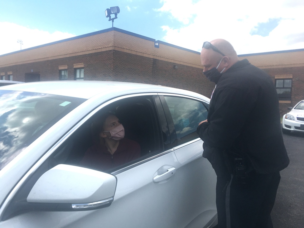 police officer talking to girl through car window