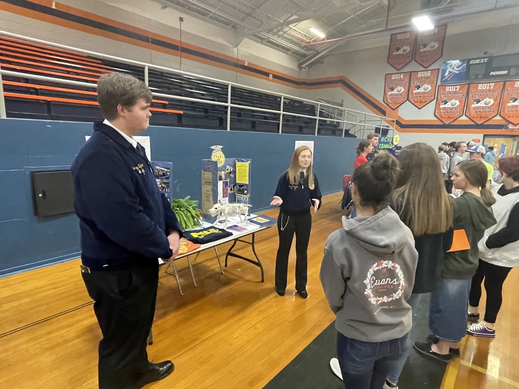 FFA boy and girl talking to group of students