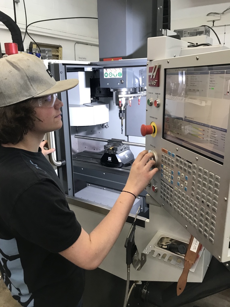 boy programming machining equipment