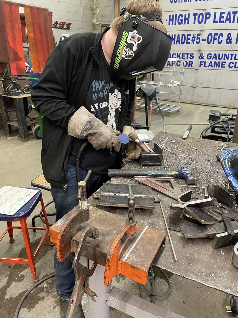 boy welding at bench