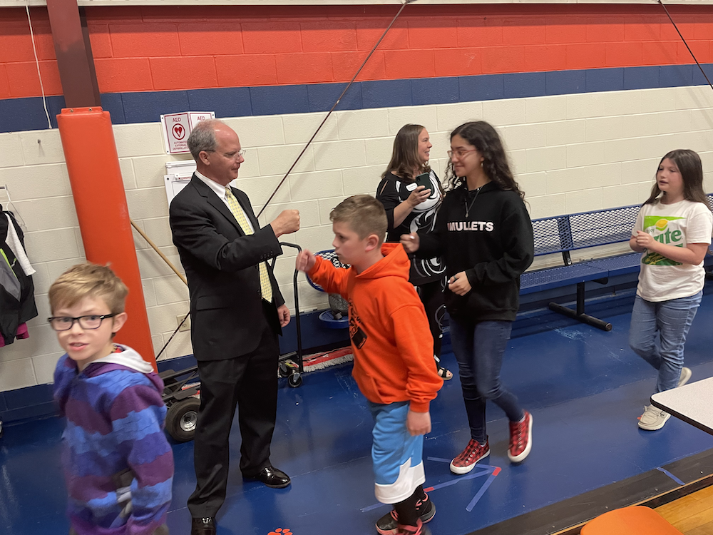 Rep Brett Guthrie fist bumps students as they exit gym