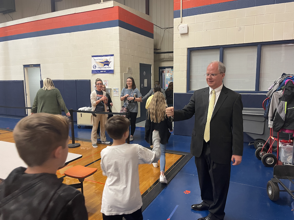 Rep Brett Guthrie fist bumps students as they exit gym