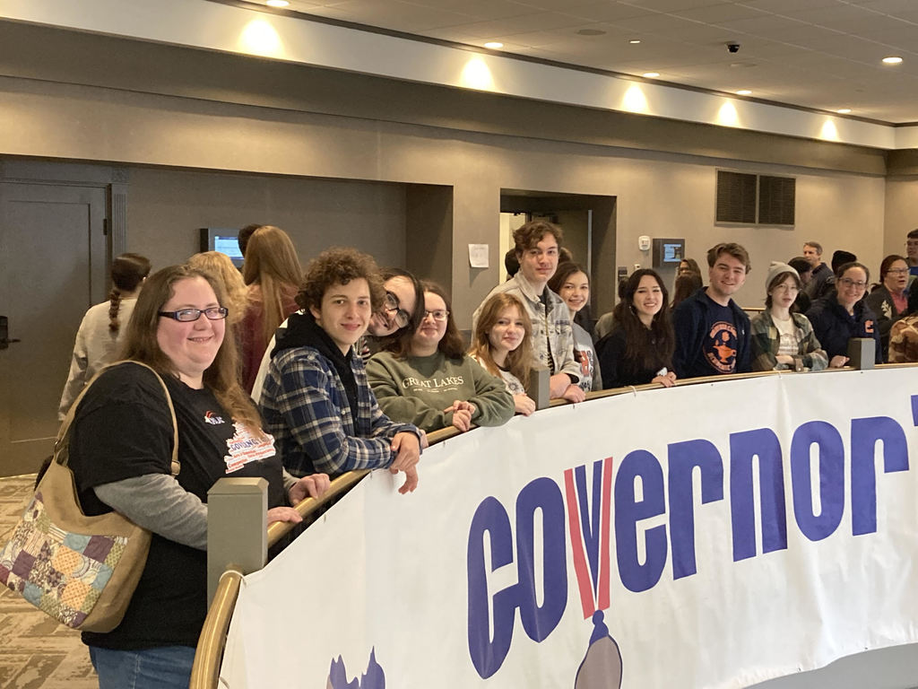 GCHS Academic team members pose in a row behind a Governor's Cup Banner below them