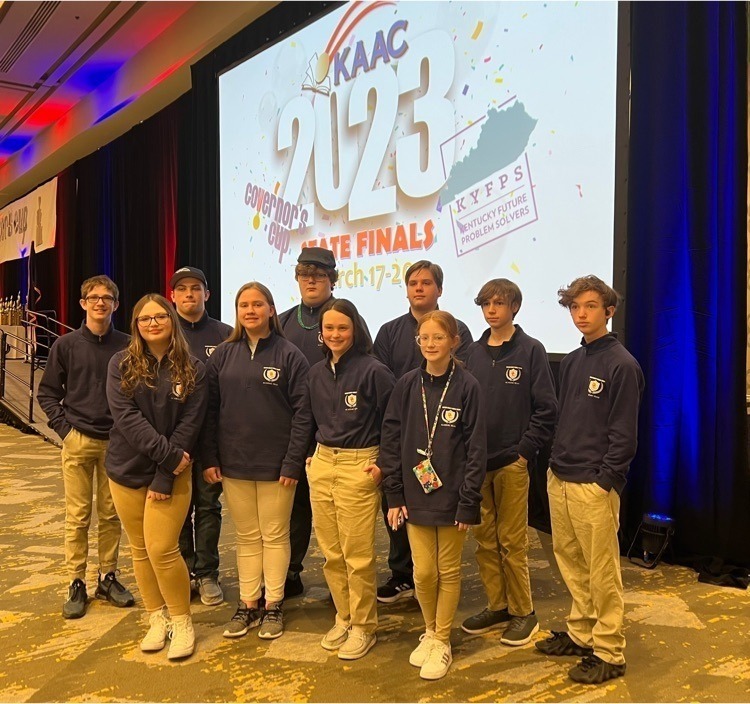 GCMS Academic Team members pose in two rows in front of a KAAC 2023 State Finals screen