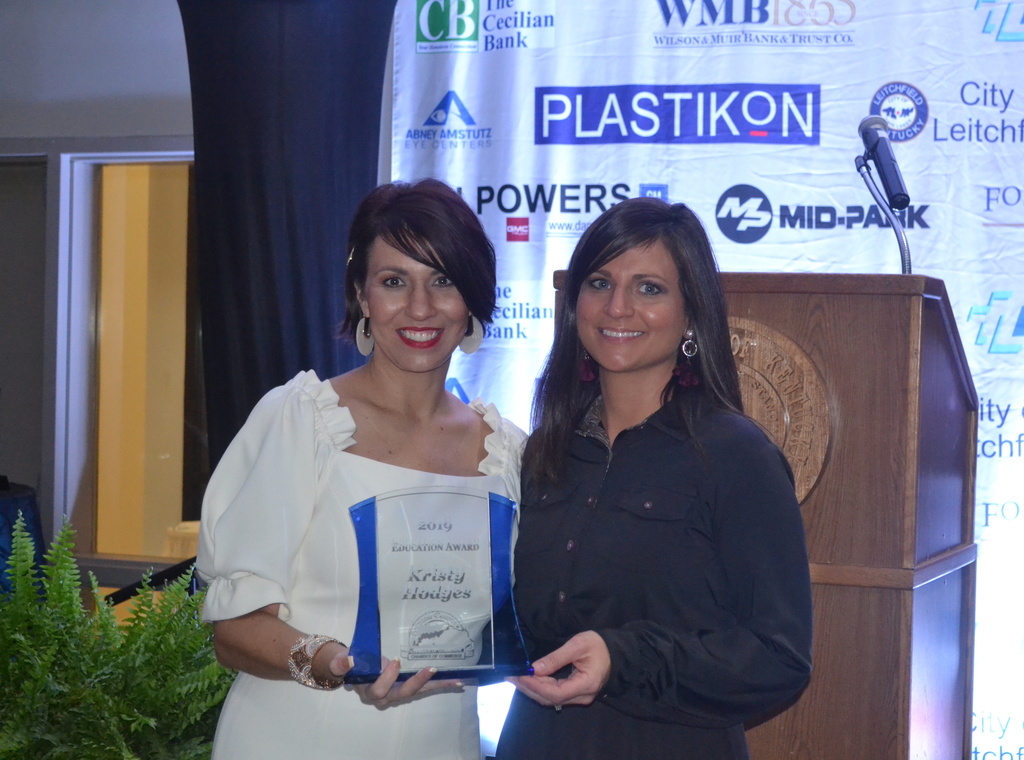 Misty Thomas and Kristy Hodges holding an award.